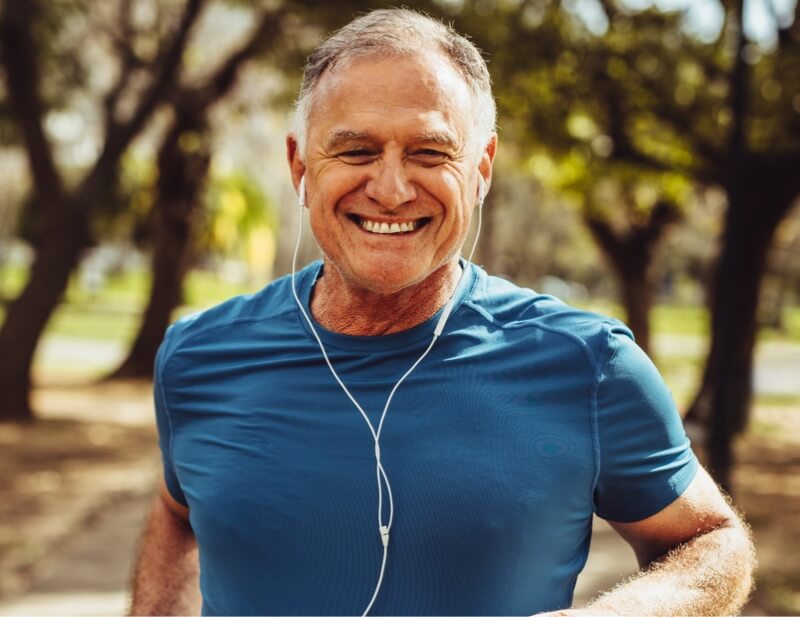 Smiling man jogging outside
