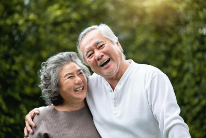 Smiling couple outside embracing